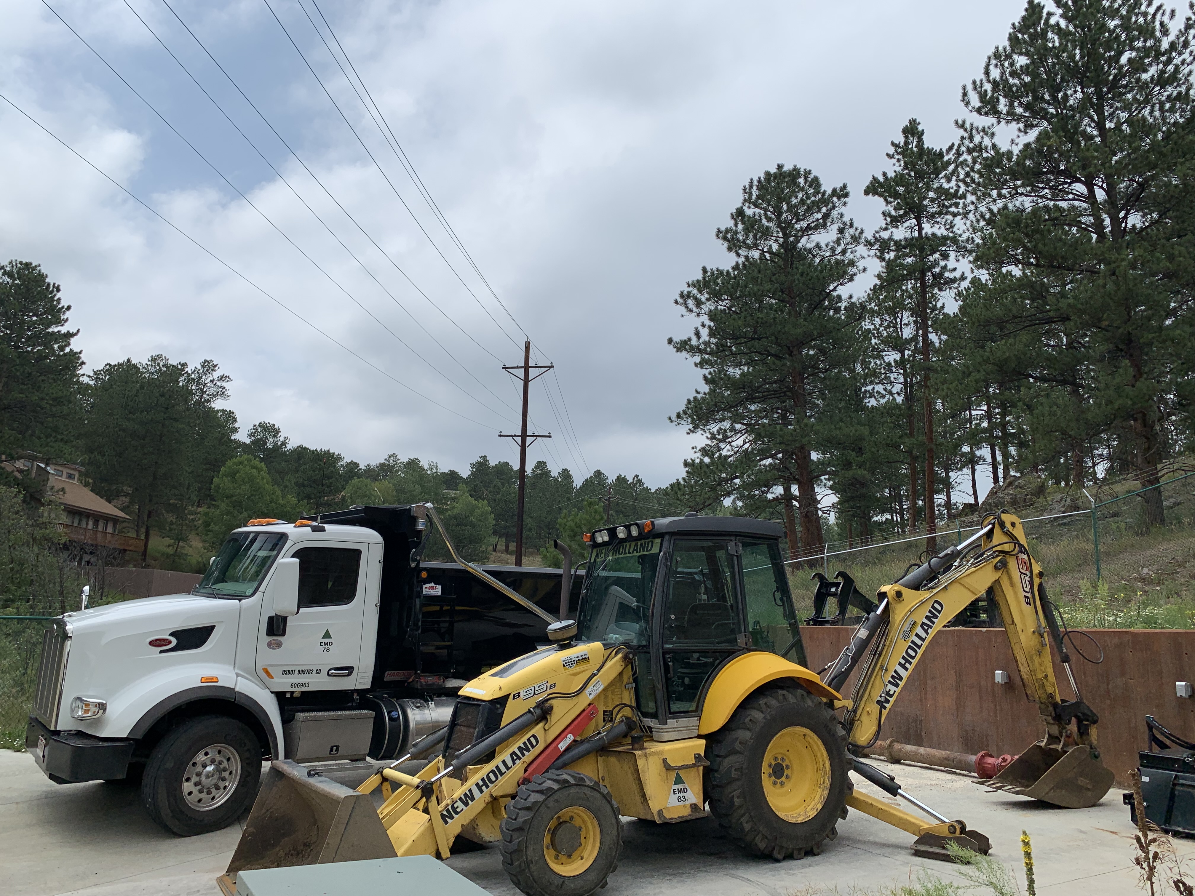 Picture of the dump truck and new holland back hoe that the C&D department operates.